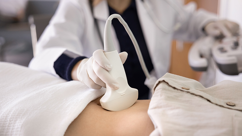 Woman undergoing an ultrasound examination to prepare for surgical abortion procedure
